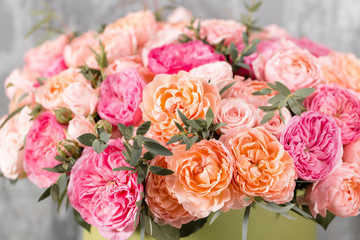 beautiful bouquet of mixed flowers in a box on wooden table. the work of the florist at a flower shop
