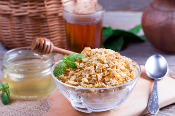 Healthy breakfast. Granola with honey on table.