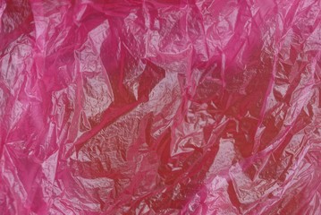 пластиковая текстура из куска мятого красного яркого целлофана 