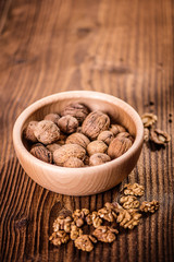 walnuts shells and kernels on old rustic wood background 