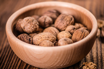 walnuts shells and kernels on old rustic wood background 