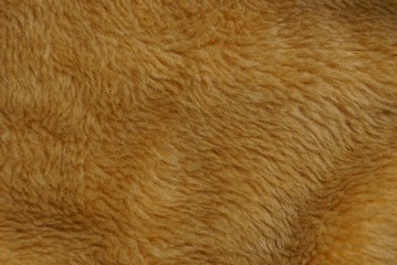 коричневая текстура из натурального  меха на части шубы
