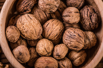 walnuts shells and kernels on old rustic wood background 