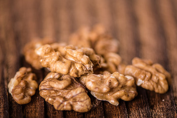 walnuts shells and kernels on old rustic wood background 