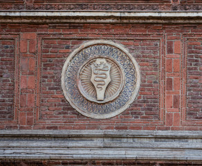the snake, symbols of the ancient Lords of Milan, on the red brick wall of an ancient building