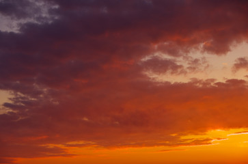Fototapeta na wymiar Fiery, orange and red colors sunset sky as background