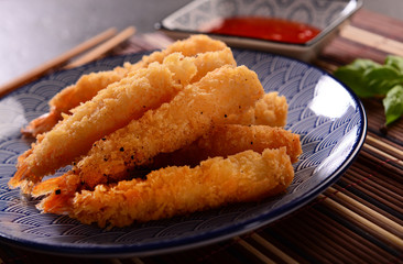 Fried shrimps on sticks in crispy coating