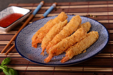 Fried shrimps on sticks in crispy coating