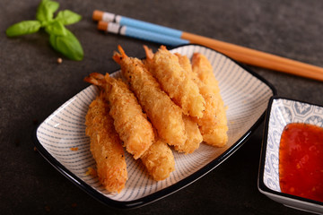 Fried shrimps on sticks in crispy coating