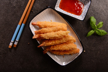 Fried shrimps on sticks in crispy coating