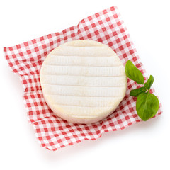 Piece of camembert cheese isolated on white background. From top view.