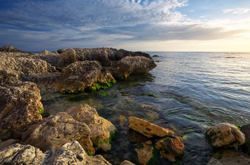 Fototapeta na wymiar Beautiful landscape with stones and moss in the sea at sunset in the Crimea