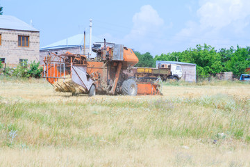 Fototapeta na wymiar An old tractor working in a field