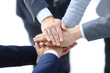 Top view of young people putting hands together