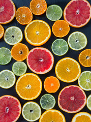 citrus fruit slices on dark surface