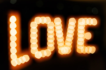 Glowing letters Love made of light bulbs