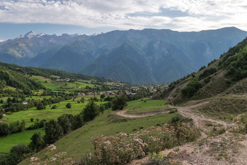 Fototapeta na wymiar Svaneti village under huge mountais
