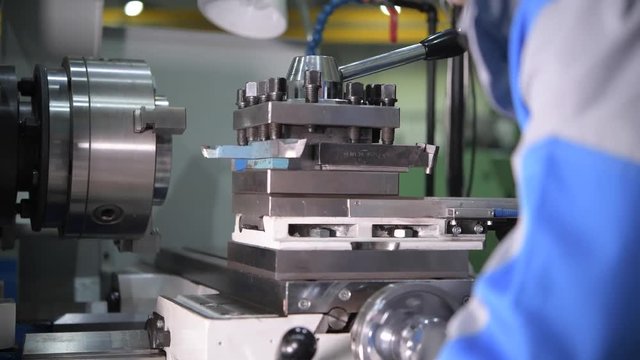 Metal Working Industry. Metal Lathe Worker in Action. 4K Footage with Slight Motion.