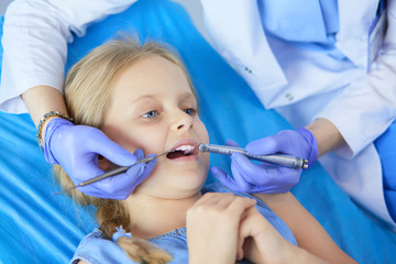 Little girl sitting in the dentists office