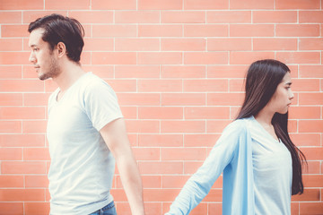 Portrait of couple asian young woman and man outdoor with relationship problem together, emotion unhappy concept.