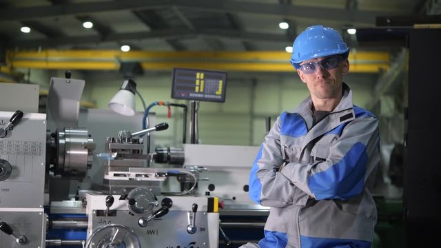Satisfied Caucasian Metal Processing Engineer in Front of Metal Lathe Machine on the Production Line