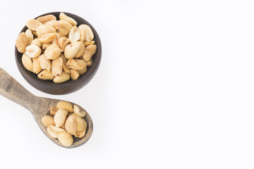 Toasted peanuts on wooden background - Arachis hypogaea