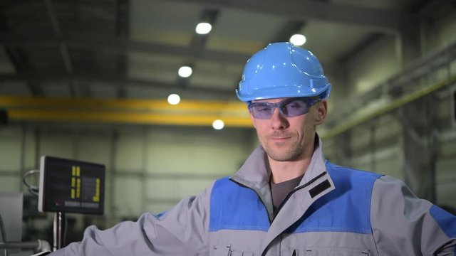 Caucasian Worker Wearing Safety Glasses and Blue Hard Hat. Caucasian Engineer Portrait.