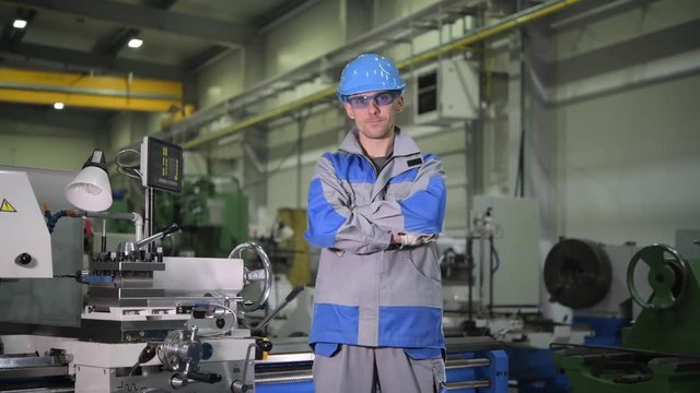 Satisfied Caucasian ProductionLine Worker in Front of Metal Lathe Machine
