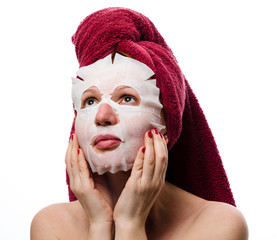 girl with a sheet cosmetic paper mask on her face white background