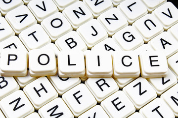 Police text word crossword title caption label cover background. Alphabet letter toy blocks. White alphabetical letters.