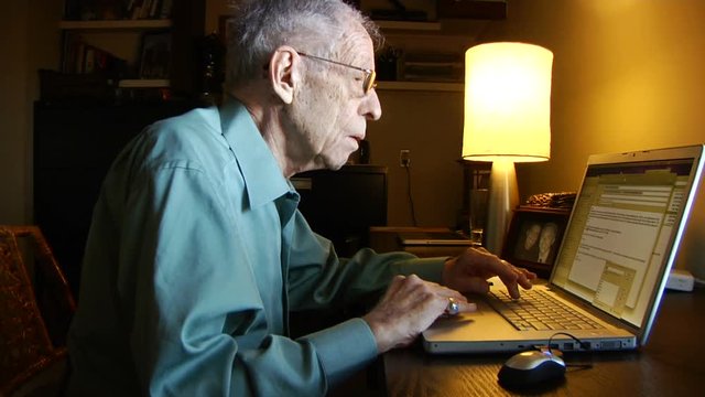 Elderly Man on laptop computer checking e-mail