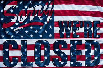 government shutdown represented by a sorry we're closed sign outline with american flag background - 189267873