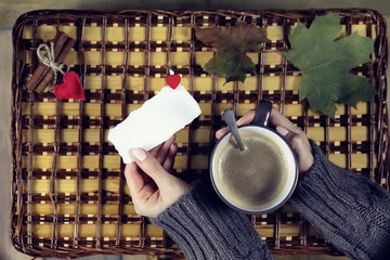 Naklejka na ściany i meble woman drinking coffee and looking at the card Valentine's Day