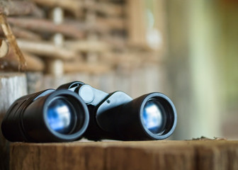 Binoculars on a Tree Trunk (Adventure/ Exciting Travel Concept)