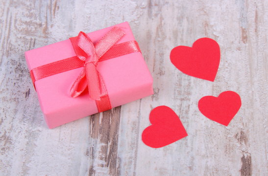 Gift for birthday, valentine or other celebration and red hearts