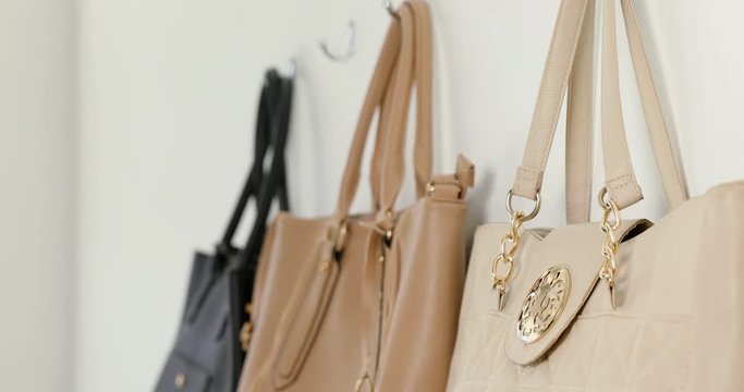 Various purses hanging on hook 