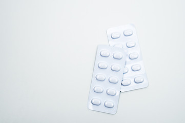 Tablets pill in white blister pack for light resistance packaging isolated on white background....