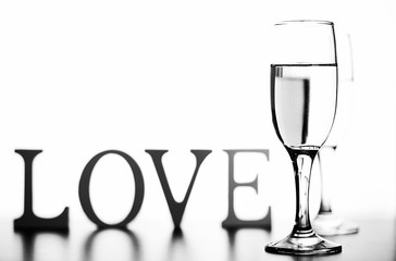 monochrome photo of champagne on white table on white background