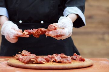 The cook cuts meat for cooking barbecue