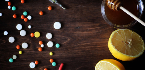 Drugs and pills on a wooden table. Various means to prevent cold