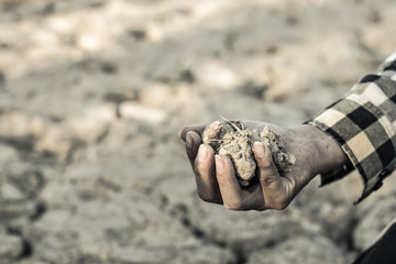 Man on a drought-stricken land in hopes of recovering, Drought crisis concept.