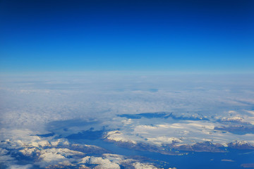 Fototapeta na wymiar Aerial view of snow and misty horizon winter vacation on white snowy mountains - Trip wander to exclusive luxury destinations