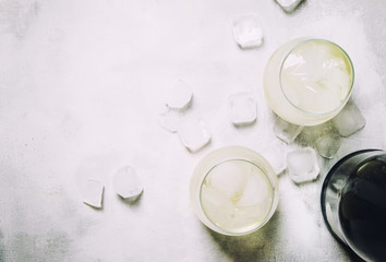 Festive Alcoholic Cocktail Prosecco On The Rocks With Dry Sparkling Wine And Ice Cubes, Gray Stone Background, Top View