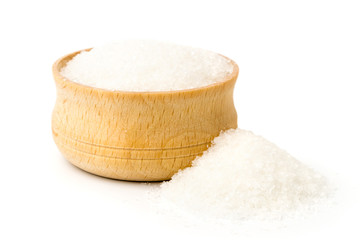 Sugar in wooden plate and scattered, isolated.