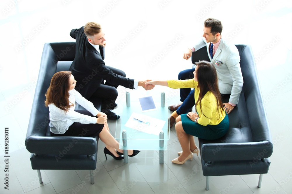 Wall mural business people shaking hands, finishing up a meeting. - Wall murals
