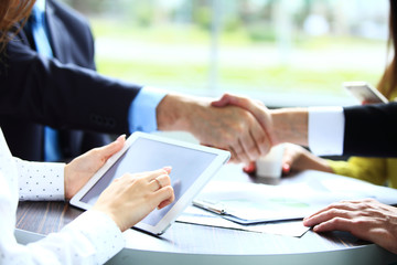Business people shaking hands, finishing up a meeting.