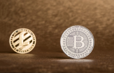 Cryptocurrency Lite coin,Silver Bitcoin on golden rough background,Digital cryto currencies.Virtual digital money.