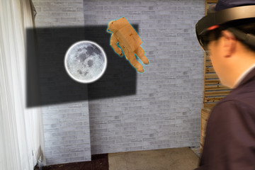 education industrial technology concept, man (blurred) using smart glasses study history astronaut to the moon in 3d by using augmented mixed virtual reality Elements of this image furnished by NASA