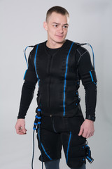 Fitness man in an electric stimulation suit