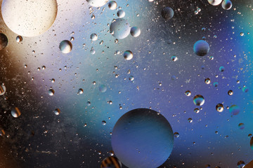 Oil bubbles in an aqueous medium on the border with a glass surface. Abstract Screen Saver.